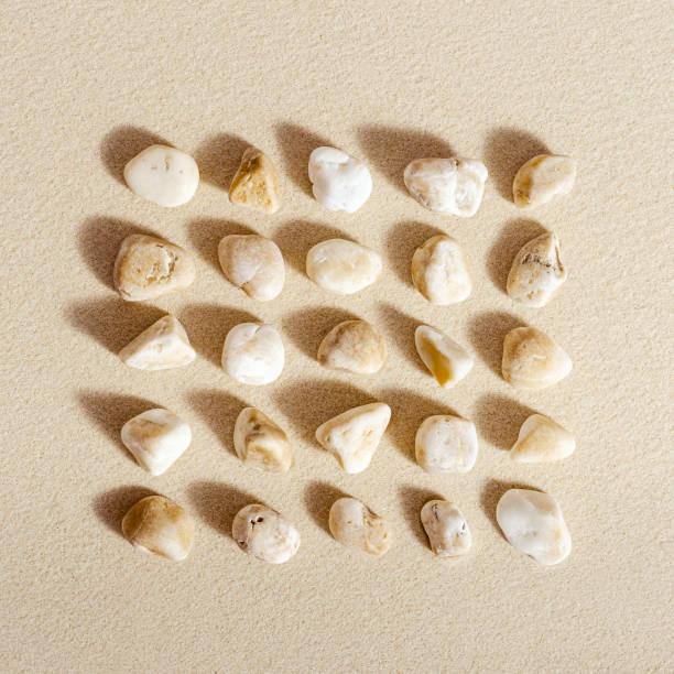 istock Pattern with close up pebble sea stones on sand texture. Square composition from natural stone neutral natural tones. Minimal style background 1362364370