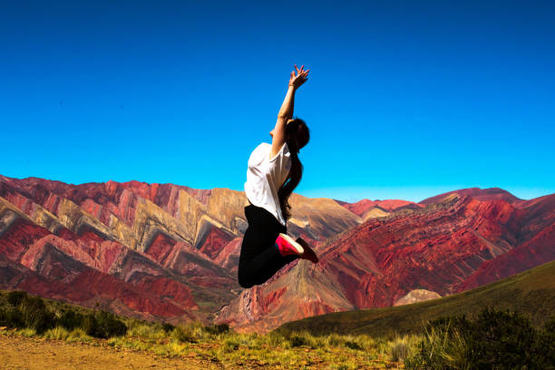 istock Young Girl jumping in the mountains 1362366252