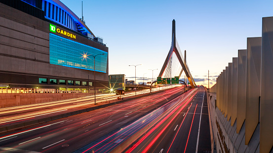 Boston, MA, USA - September 10, 2018: The historic architecture of Boston in Massachusetts, USA showcasing the TD Garden building and the modern Zakim Bridge at night.