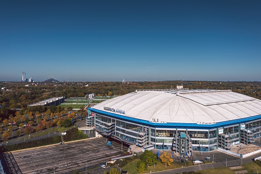 Gelsenkirchen, North Rhine-Westphalia, Germany - October 2021: Arial panoramic view on Veltins Arena (also known as Arena AufSchalke) at sunset, home stadium for Bundesliga team FC Schalke 04