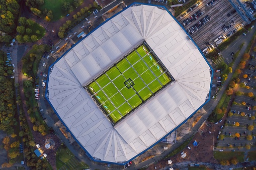 Gelsenkirchen, North Rhine-Westphalia, Germany - October 2021: Arial panoramic view on Veltins Arena (also known as Arena AufSchalke) at sunset, home stadium for Bundesliga team FC Schalke 04