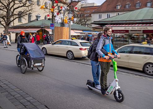 Young people on a electric stroller on a cold winter day in the center of the German city Munich