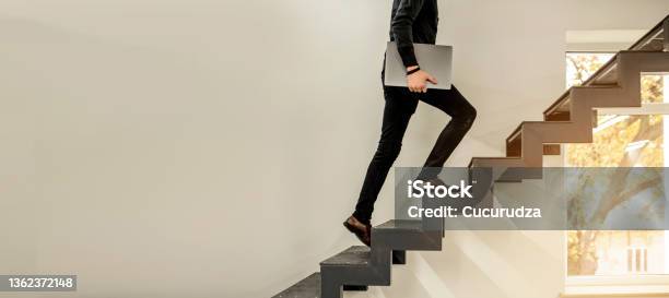 Man Climbing On A Stairs And Holding A Laptop Stock Photo - Download Image Now - Staircase, Steps, Climbing