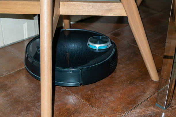 istock intelligent robot vacuum cleaner stuck between the chairs while cleaning the floor 1362373662
