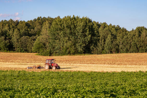 istock tractor plowing a field on a clear day 1362375580