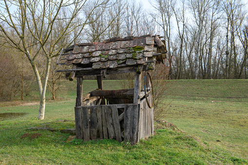 An old draw well with a half-ruined roof in Lonjsko Polje National Park in Croatia.