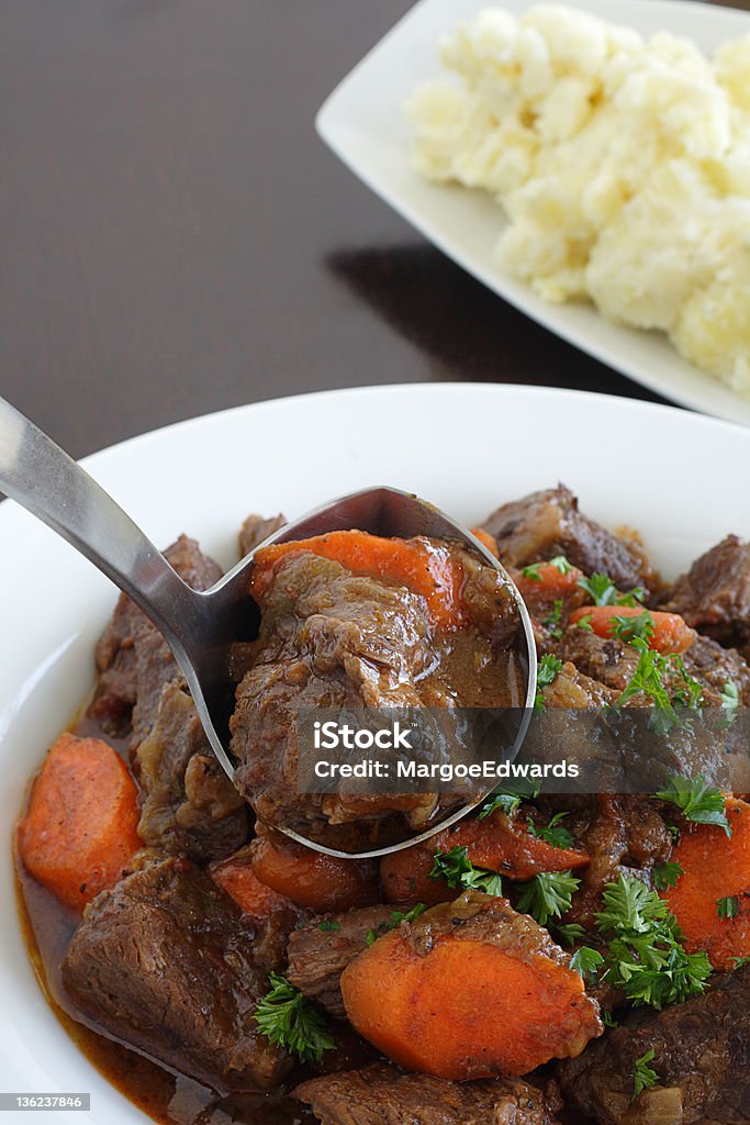 Beef stew Silver ladle serving delicious meal into bowl Beef Stew Stock Photo