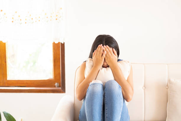 istock The depression girl sitting on sofa and crying at home. 1362378555