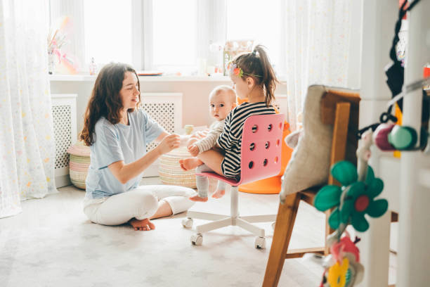 Playful young family at home. Playful young family at home. 6 9 months stock pictures, royalty-free photos & images