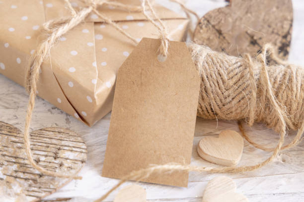 istock Valentines present with blank gift tag and hearts top view, Rustic label Mockup 1362379428