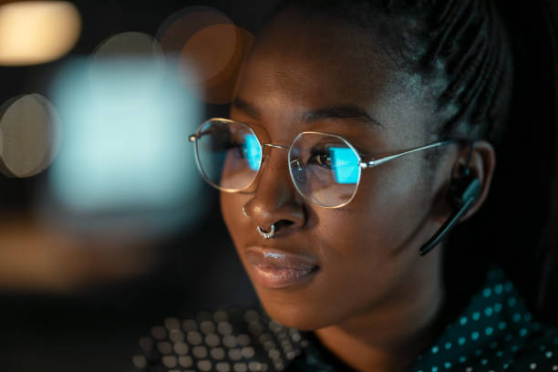 istock Smart business woman working with computer while talking with earphone sitting in modern startup office. 1362381053