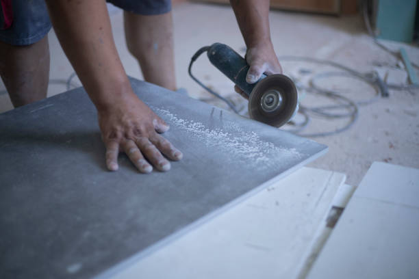 istock hands of latin worker cutting a tile with the electric grinder 1362382151