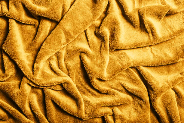 istock Yellow fabric background. Golden color blanket texture. Wave material pattern. 1362382847