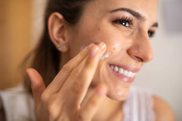 istock Woman Applying Daily Moisturizing Cream 1362385641
