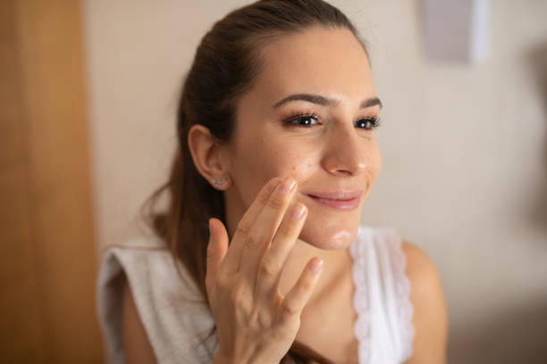 istock Woman Applying Daily Moisturizing Cream 1362385660