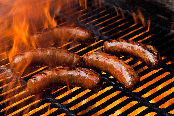 Grilled Brats Grilling brats in flames bratwurst stock pictures, royalty-free photos & images