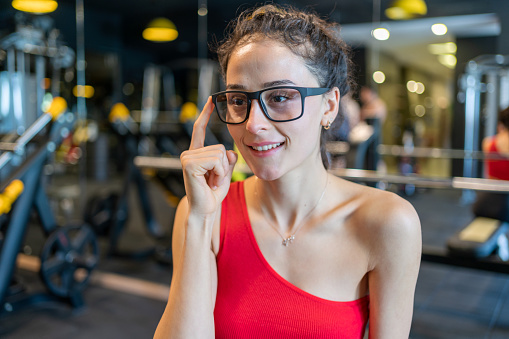 Fitness Woman Using Smart Glasses And Exercising At Gym