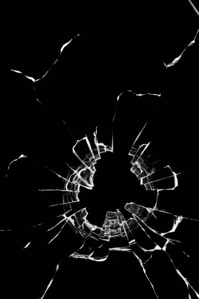 istock Texture of cracks on the window, broken glass with a hole on a black background 1362387473