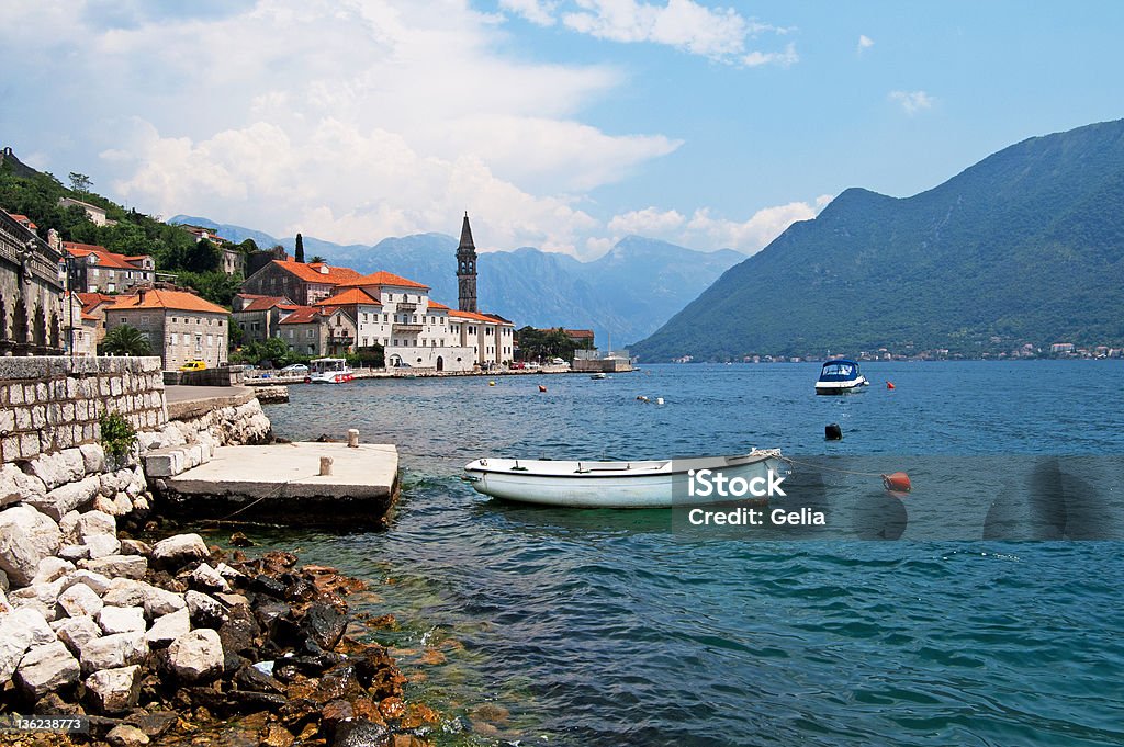 Quiet historic town of Perast, Montenegro Quiet historic town of Perast with white houses, boats on the slopes of Mount St. Elias, Montenegro Adriatic Sea Stock Photo