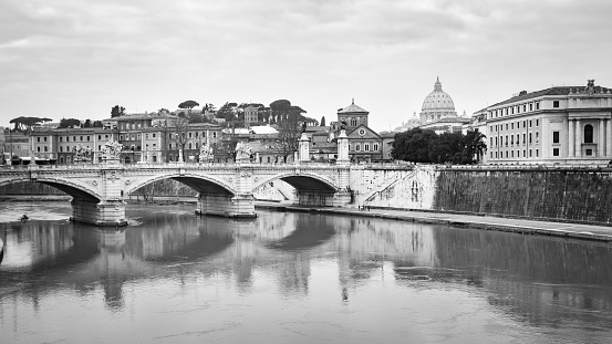 Ancient Roman bridge with reflections in Rome, Italy