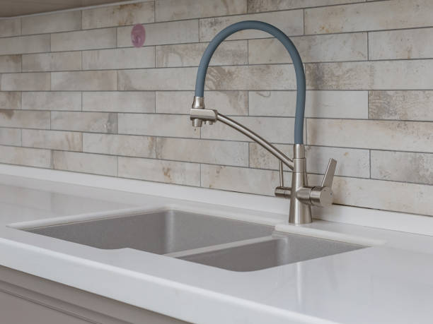 istock Detail of a gray rectangular designer kitchen sink with a water tap. 1362388631