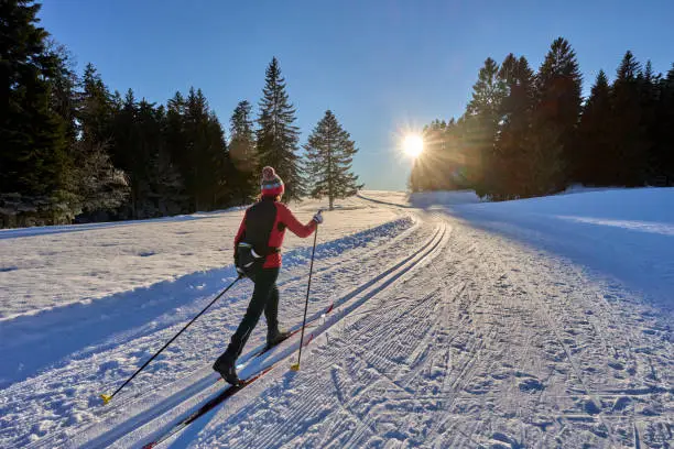 Photo of woman cross country skiing in the alps