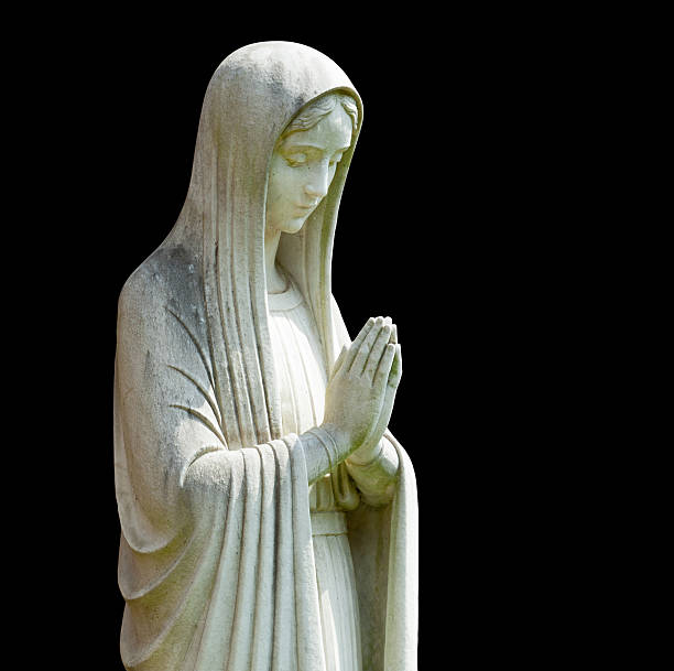 Isolated statue of Mary Statue of Mary praying in profile with isolation path and isolated against black statue photos stock pictures, royalty-free photos & images