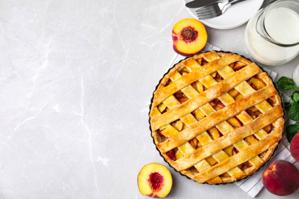 istock Delicious fresh peach pie served on light grey table, flat lay. Space for text 1362395628