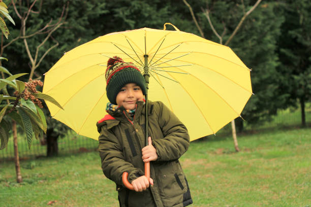 istock yellow umbrella and child 1362400494