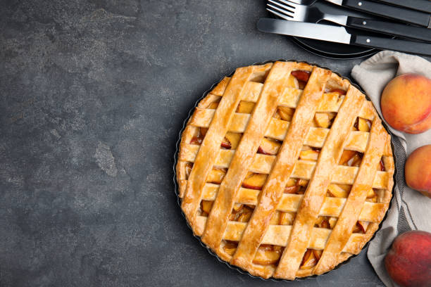 istock Delicious peach pie and fresh fruits on grey table, flat lay. Space for text 1362402071