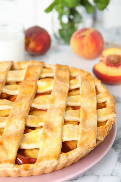 istock Delicious peach pie on white marble table, closeup 1362402210