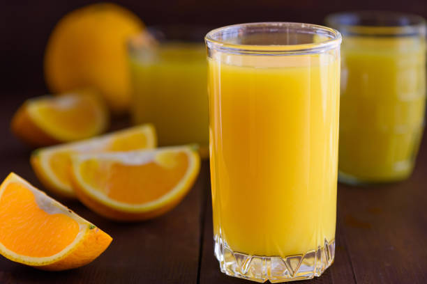 Orange juice on wooden table. Fresh summer drink stock photo