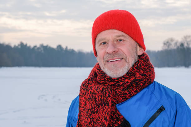 istock Elderly man standing in winter forest, resting after exercise 1362404009