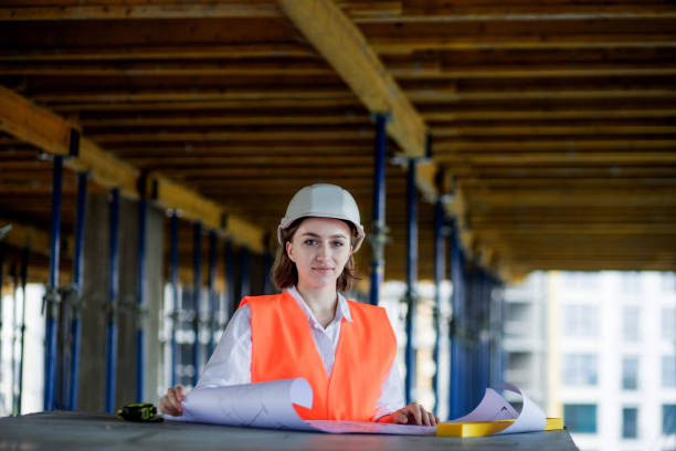 istock Architect or engineer working, browsing building project indoor of construction site with blueprint plan. Woman construction engineers or architects working people 1362405998