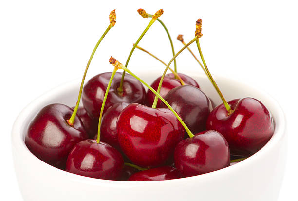 istock Red ripe cherries in a bowl on white background 136241475