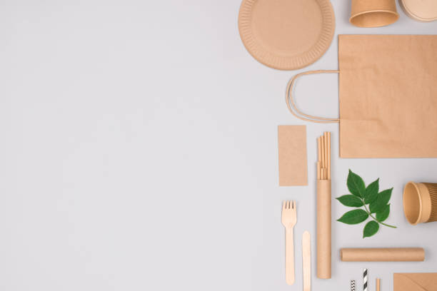 istock Different eco-friendly tableware and kraft paper food packaging on gray background. Street food paper packaging - cups, plates, straws, containers and paper bags. Mockup, flat lay 1362417438