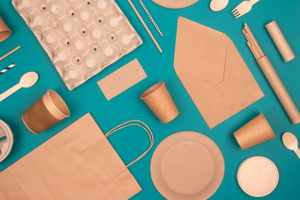 istock Flat lay with eco-friendly tableware and sustainable packaging. Kraft paper food packaging on green background. Street food paper packaging, recyclable paperware, zero waste packaging concept 1362417445