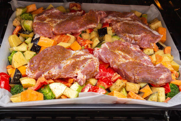 istock Finely chopped and seasoned vegetables with pork, placed on a baking sheet, before baking on parchment in the oven. Potatoes, bell peppers, squash, pumpkin and broccoli. Close-up 1362418283
