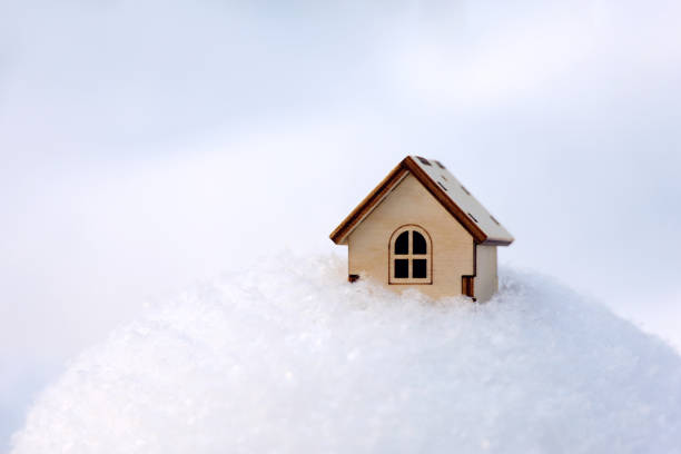 istock Wooden house model in a snow 1362420946