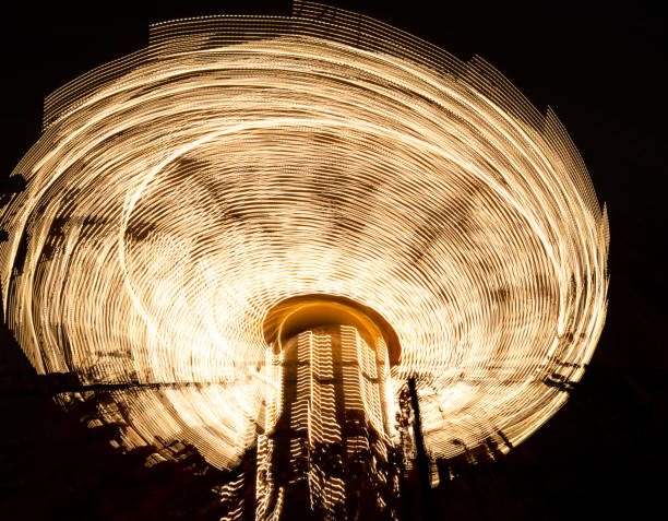 istock Rotating swing ride in amusement park at night 1362421042