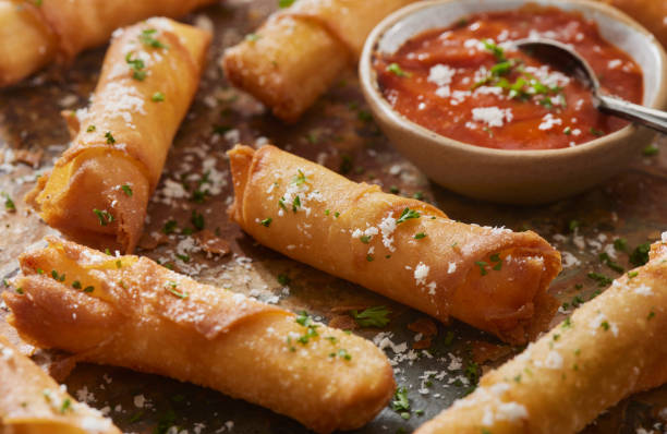 Crispy Mozzarella Sticks wrapped in Wonton Wrappers Mozzarella Sticks wrapped in Wonton Wrappers with a Marinara Dipping Sauce Cheese String stock pictures, royalty-free photos & images