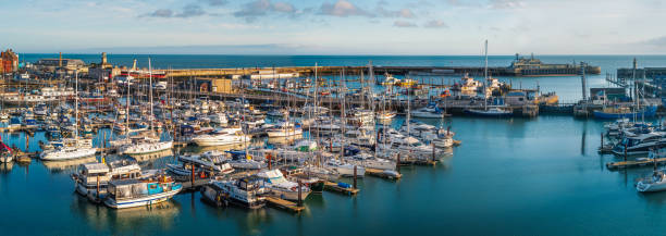 Panoramic image of the historic Royal Harbour on a bright New Years Eve. The inner and outer basin of the harbour, plus the harbour wall and light house can be seen. Ramsgate, England - Dec 31 2021 Panoramic image of the historic Royal Harbour on a bright New Years Eve. The inner and outer basin of the harbour, plus the harbour wall and light house can be seen. ramsgate stock pictures, royalty-free photos & images