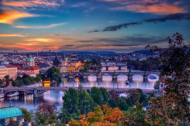 Charles bridge, Karluv most and Lesser town tower, Prague in autumn at sunrise, Czech Republic.