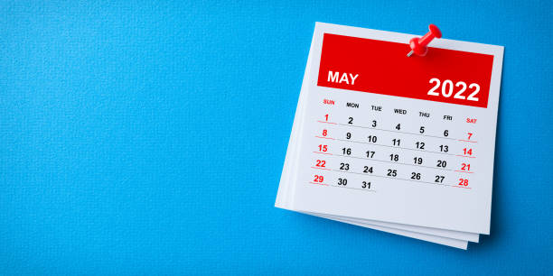 istock White Sticky Note With 2022 May Calendar And Red Push Pin On Blue Background 1362427404
