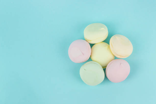 istock Close-Up Of Multi Colored Marshmallows looks like macaroons In Plate On Blue Background. Marshmallow concept. 1362428105