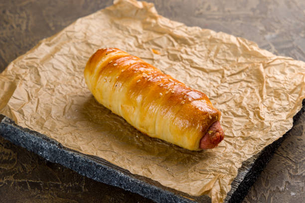 sausage in the dough on wooden board
