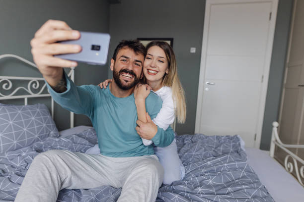 istock Happy young couple in bed 1362430635