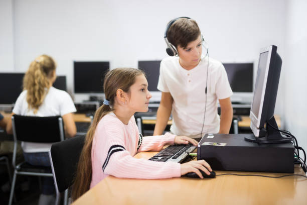 istock Young boy and girl in computer class 1362430664