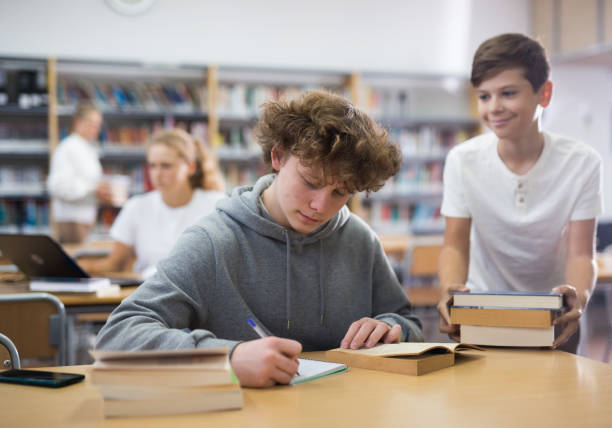 istock Fifteen-year-old schoolboy writes an synopsis 1362431394