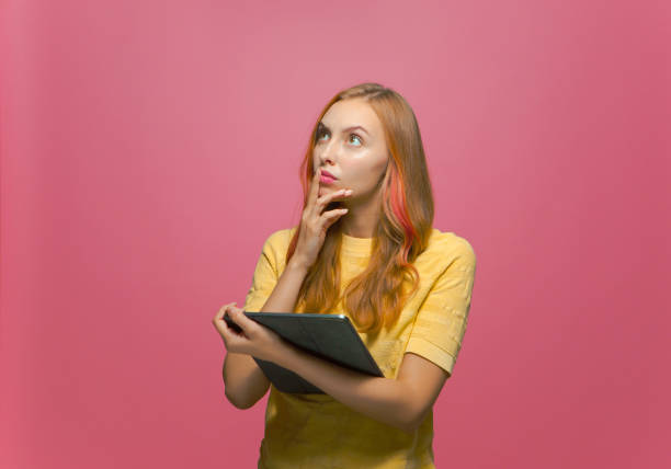 istock Thoughtful young girl blogger with tablet look up think pondering over ideas, create content for social network 1362432520